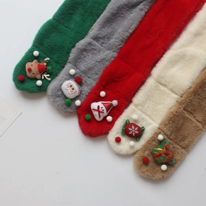 Flat lay view of colorful plush Christmas scarves with cute reindeer and Santa decorations