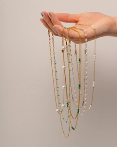Detail of 18K gold plated stainless steel necklaces with pearls and colorful beads