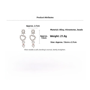 Detailed view of silver heart earrings with rhinestones, rice beads and alloy charms