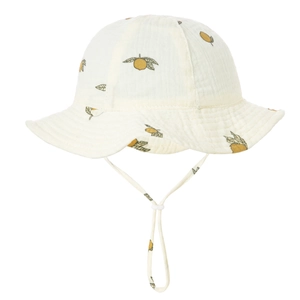 Close-up of baby sun hat with lemon print, cotton gauze texture and adjustable strap
