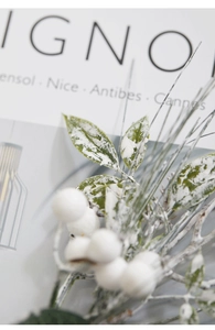 Macro shot of artificial frosted white berries and snowy pine branches for Xmas decor