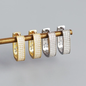 Detail of U-shaped S925 silver hoop earrings with micro-pave cubic zirconia stones