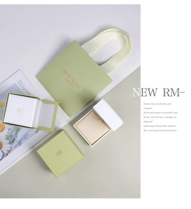 Detail of luxury silk jewelry box set with ribbons and elegant gift bags in matcha green