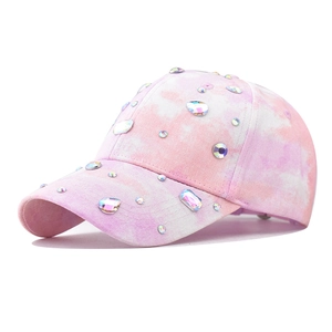 Detailed view of tie-dye baseball cap with sparkling colorful rhinestones and crystals