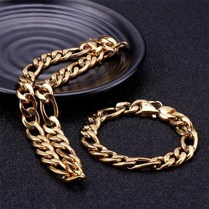 Men's gold stainless steel Figaro chain necklace and bracelet set on black display
