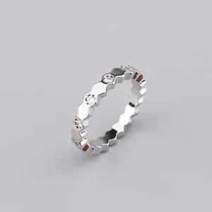 Macro shot of silver hexagon bracelet featuring cubic zirconia pavé setting detail