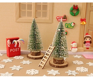 Miniature Christmas set featuring snow-covered trees, red post box, and tiny wooden ladder