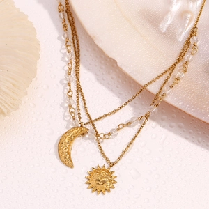 Detail of 18K gold-plated sun and moon pendants with hammered texture and beads