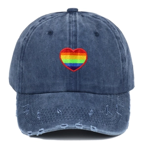 Distressed navy denim baseball cap featuring rainbow heart embroidery and worn brim details