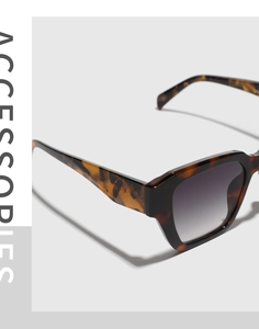 Detail of tortoiseshell square sunglasses frame with dark grey gradient lenses