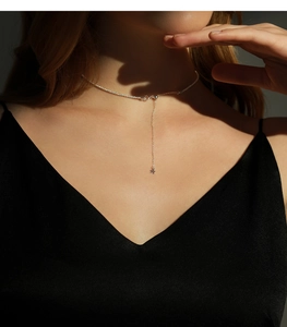 Macro detail of s925 silver Y-shaped necklace with star pendant on model neck