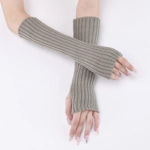 Detail of grey knitted arm warmers with striped pattern and thumb hole design