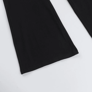 Close-up of the flared hem and fine stitching on these black lace-up jumpsuits