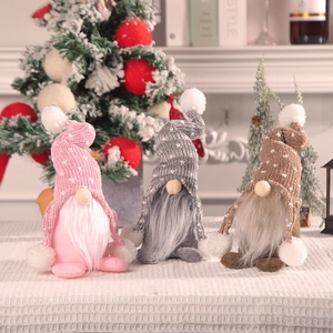 Three Christmas gnomes with knitted hats and long beards on a festive background