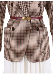Detail of wine red slim leather belt with gold buckle on houndstooth blazer