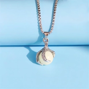 Detailed view of vintage dragon claw necklace holding a luminous orb on a silver box chain