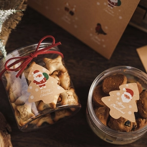 Christmas kraft paper tree tags on cookie jars with red velvet ribbons and festive decor