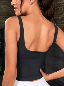 Back view of black ribbed knit sports tank top for women in a gym setting