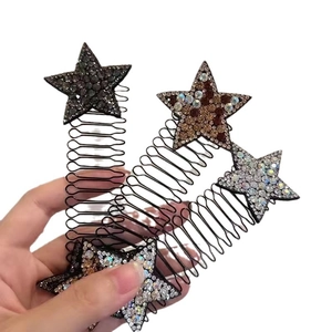 Hand holding three rhinestone star hair combs with black wire frames for hairstyling