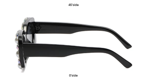 Side view detail of square black sunglasses featuring oversized pearls and sparkling rhinestones