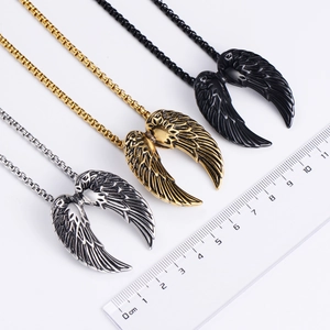 Three angel wing necklaces in silver, gold, and black finish with scale reference