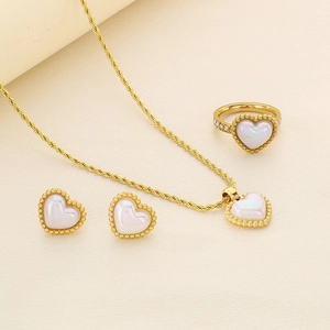 Detailed close-up of gold plated heart-shaped shell jewelry set with necklace and ring
