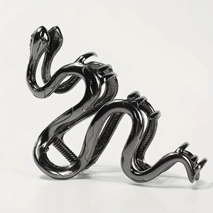 Gothic snake-shaped metal hair claw clip in gun black finish on white background