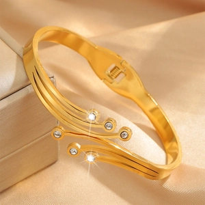 Three-layer wave gold stainless steel bangle with zircon crystals on champagne silk
