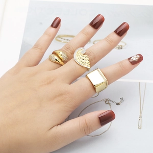 Gold plated geometric rings with zircon wings and adjustable bands on model hand