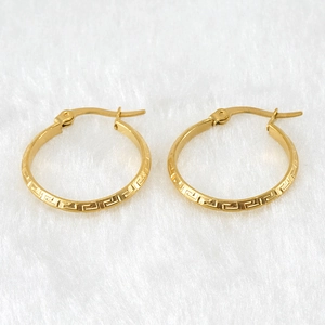 18K gold plated stainless steel hoop earrings featuring Greek key pattern on white fur