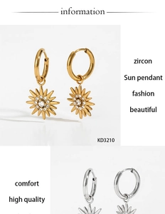 Detailed view of gold and silver sun pendant hoop earrings with zircon stones