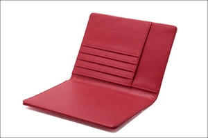 Detail view of red PU leather passport holder featuring multiple card slots and fine texture