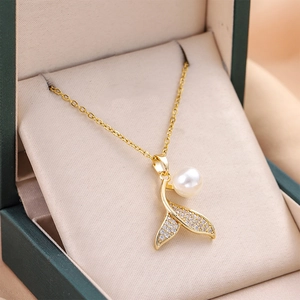 Elegant gold mermaid tail pendant necklace with shimmering pearl and micro-inlaid diamonds