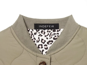 Detail of quilted jacket collar with ribbed knit texture and leopard print lining detail