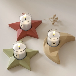 Star and moon shaped candle holder tray set in matte resin with geometric faceted design