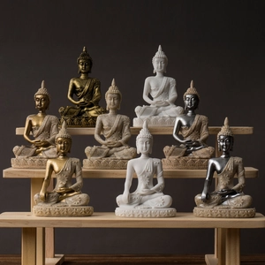 Set of 8 colorful resin Buddha statues in gold and silver on a wooden display stand
