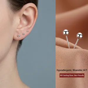 Minimalist S999 sterling silver ball stud earrings shown on model and in detail view