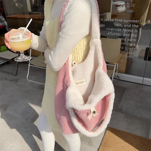 Detailed view of pink and beige plush tote bag texture with inner brand label detail