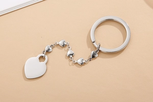 Macro shot of silver stainless steel keychain featuring a large heart-shaped pendant and link chain