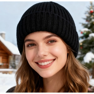 Close-up of black ribbed knit beanie worn by a model in a snowy outdoor winter setting