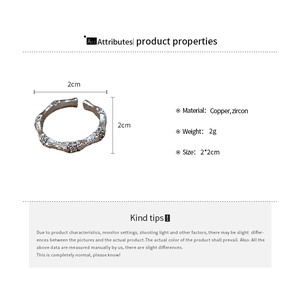 Detailed view of the bamboo joint texture on a silver-colored copper ring with zircon inlay