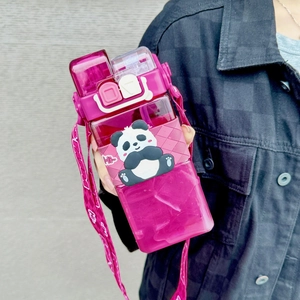 Close-up of pink square panda water bottle with double-lid design and woven strap
