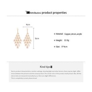 Detail of chandelier earrings with acrylic shell petals and zircon stones, 9x4cm size
