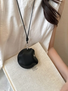Close-up of a black faux leather magnetic glasses holder necklace with white stitching