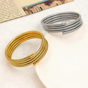 Minimalist flexible stainless steel spring coil bangle in gold and silver finish