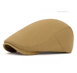 Detail of khaki newsboy cap featuring an adjustable back button and cotton twill texture
