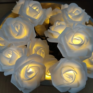 Solar powered white rose LED string lights for outdoor garden decoration with warm glow