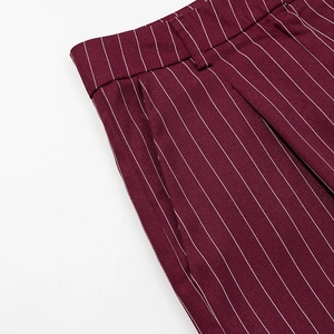 Detail view of burgundy pinstripe trousers showing waistband and pocket stitching