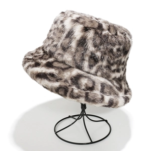 Detailed view of grey leopard print faux fur bucket hat on a black display stand