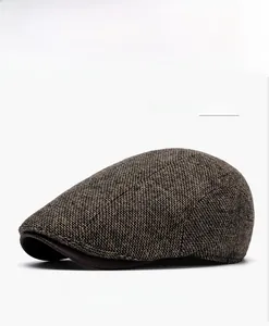 Detail shot of vintage brown tweed wool blend newsboy flat cap for winter